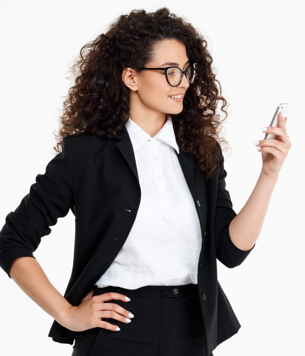 cheerful-curly-business-girl-wearing-glasses-looking-phone-min